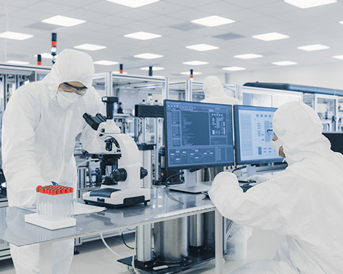 Technicians working with a microscope