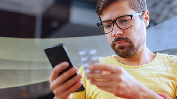 woman wearing a mask looking at phone