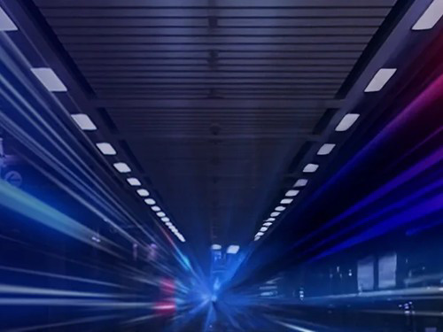 Futuristic tunnel with blue and red light streaks, creating a dynamic sense of speed and motion. 