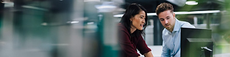 Two colleagues looking at a computer screen