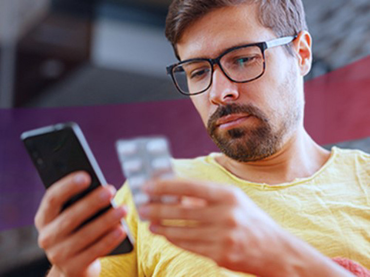 A man is searching tablet in his phone