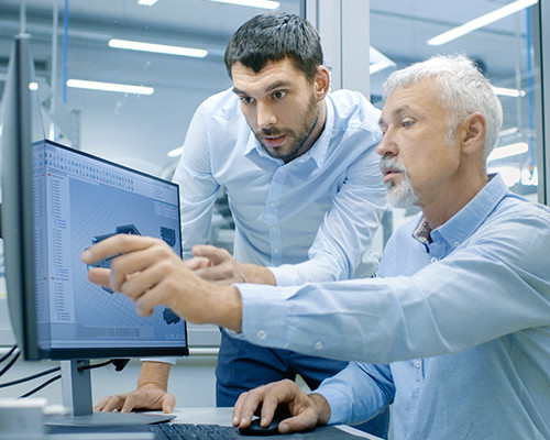 Two men discusiing about something looking at the monitor