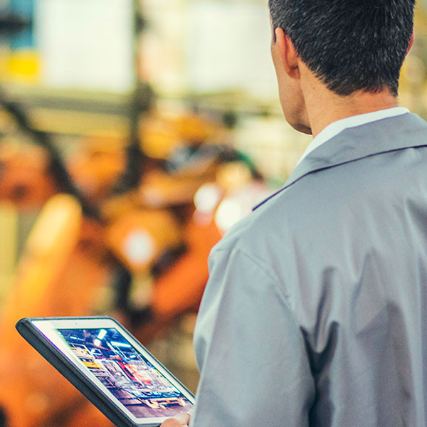 Man with tablet with machines