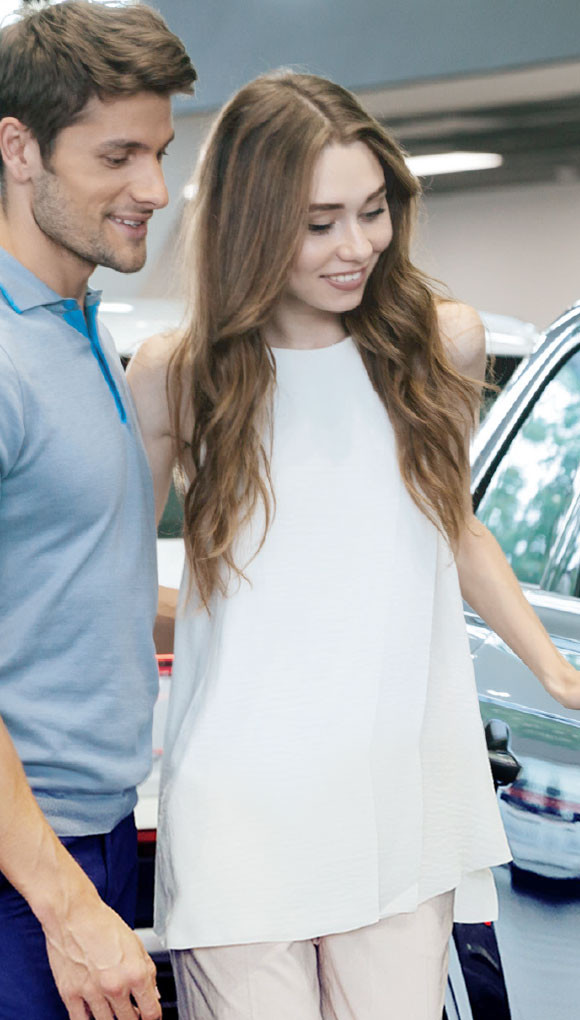 Man and woman looking at car