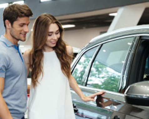 Man and woman looking at car