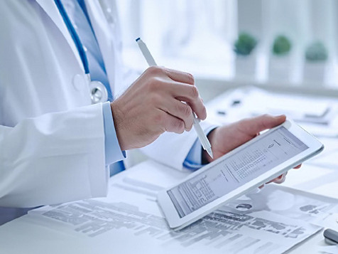 health professional scribbling on a notepad