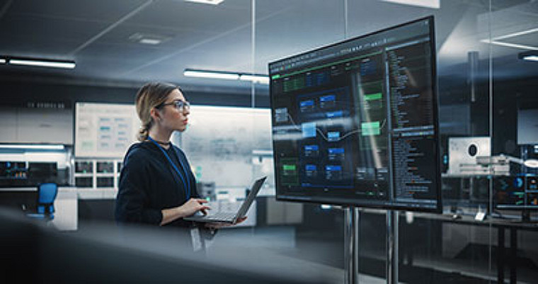 Woman working in technology center, looking at screen