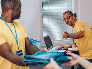 Two male nonprofit workers having a conversation.