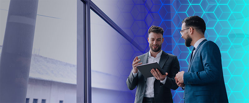 Person coding at multiple monitors in dim office