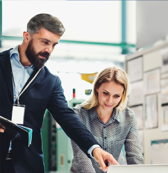 Man discussing with women pointing toward laptop