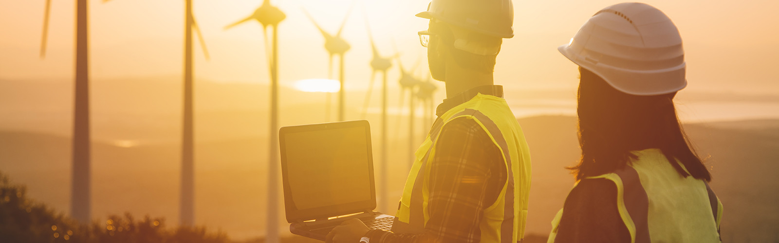 Construction workers in a windmill field.