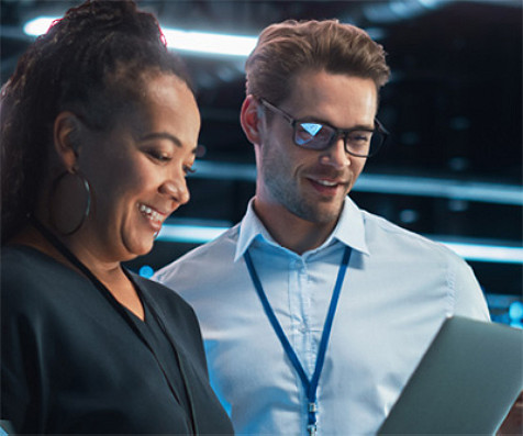 A female and male colleagues looking at a tablet device.