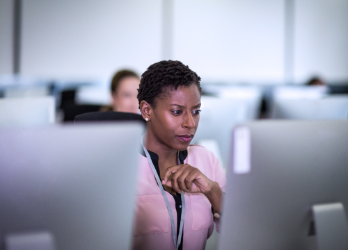 A female looking at her monitor screen.