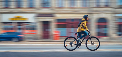 person riding a bike through a city