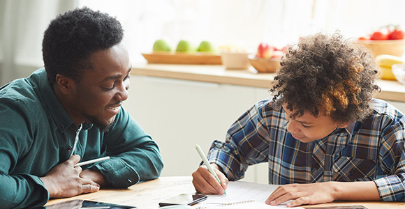 Two school boy working on assignments.