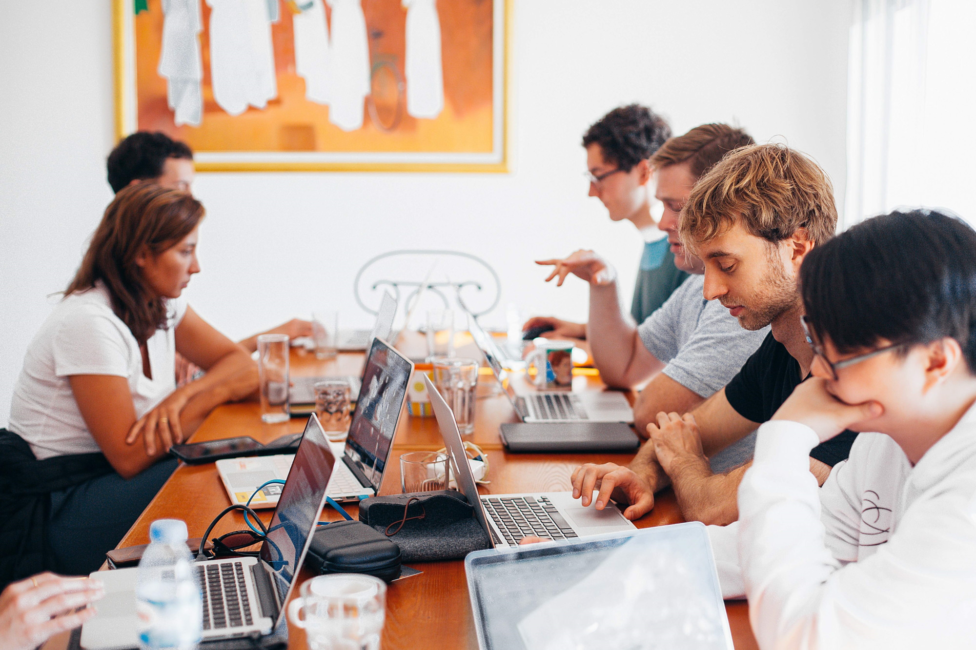 colleagues sitting at a table with their laptops