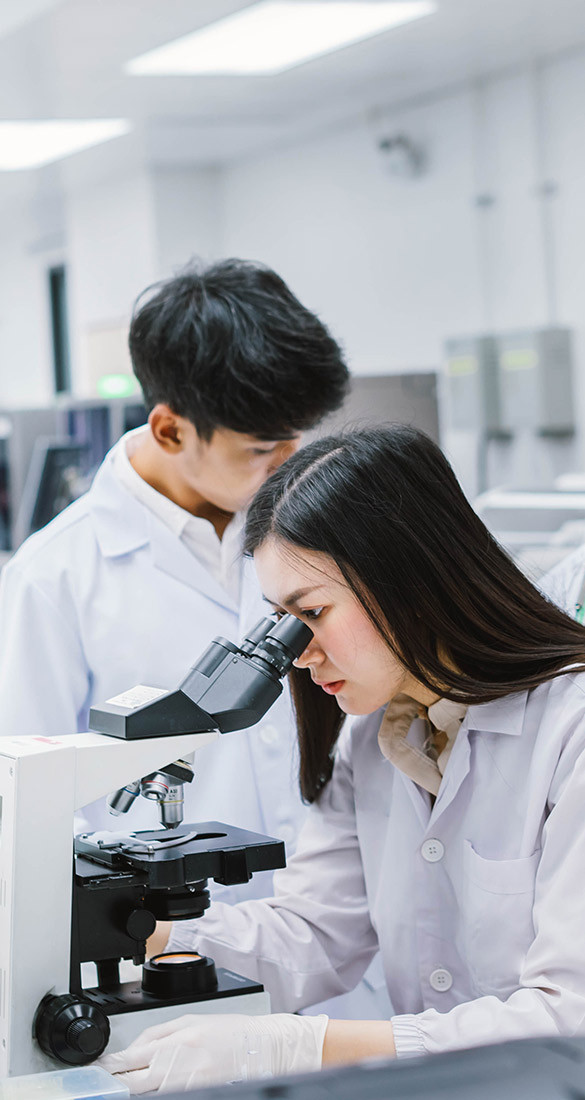 Man and woman looking at lab equipment