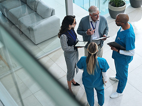 A group of medical professionals standing together talking