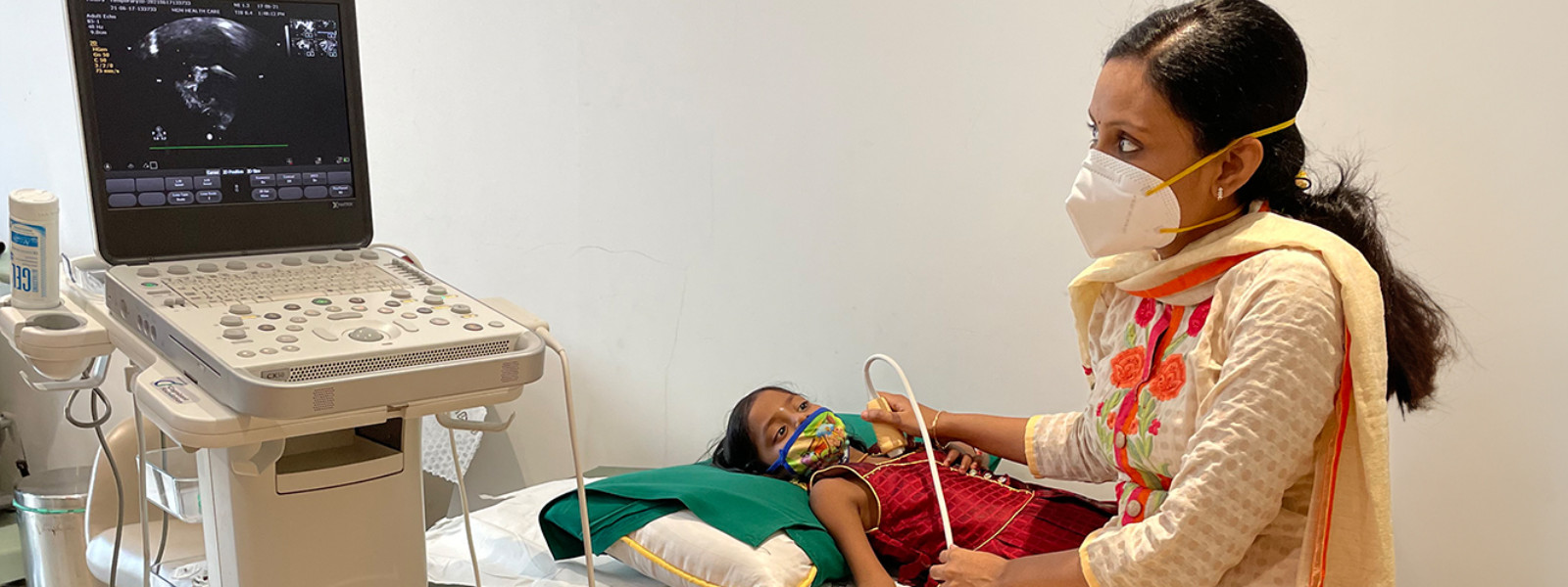 A doctor checking heart beat to a child
