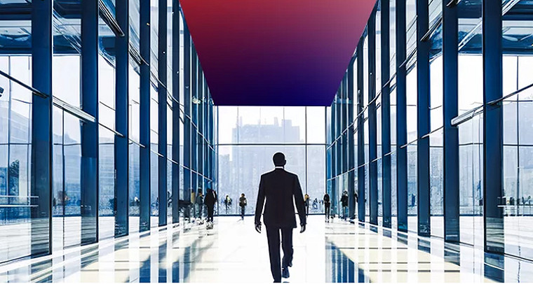 Person walking through a modern glass office corridor with reflective floors and a colorful ceiling panel.