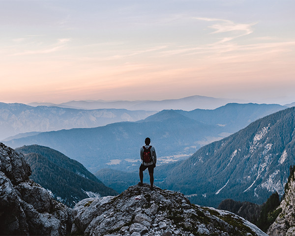 Person standing on top of a cliff