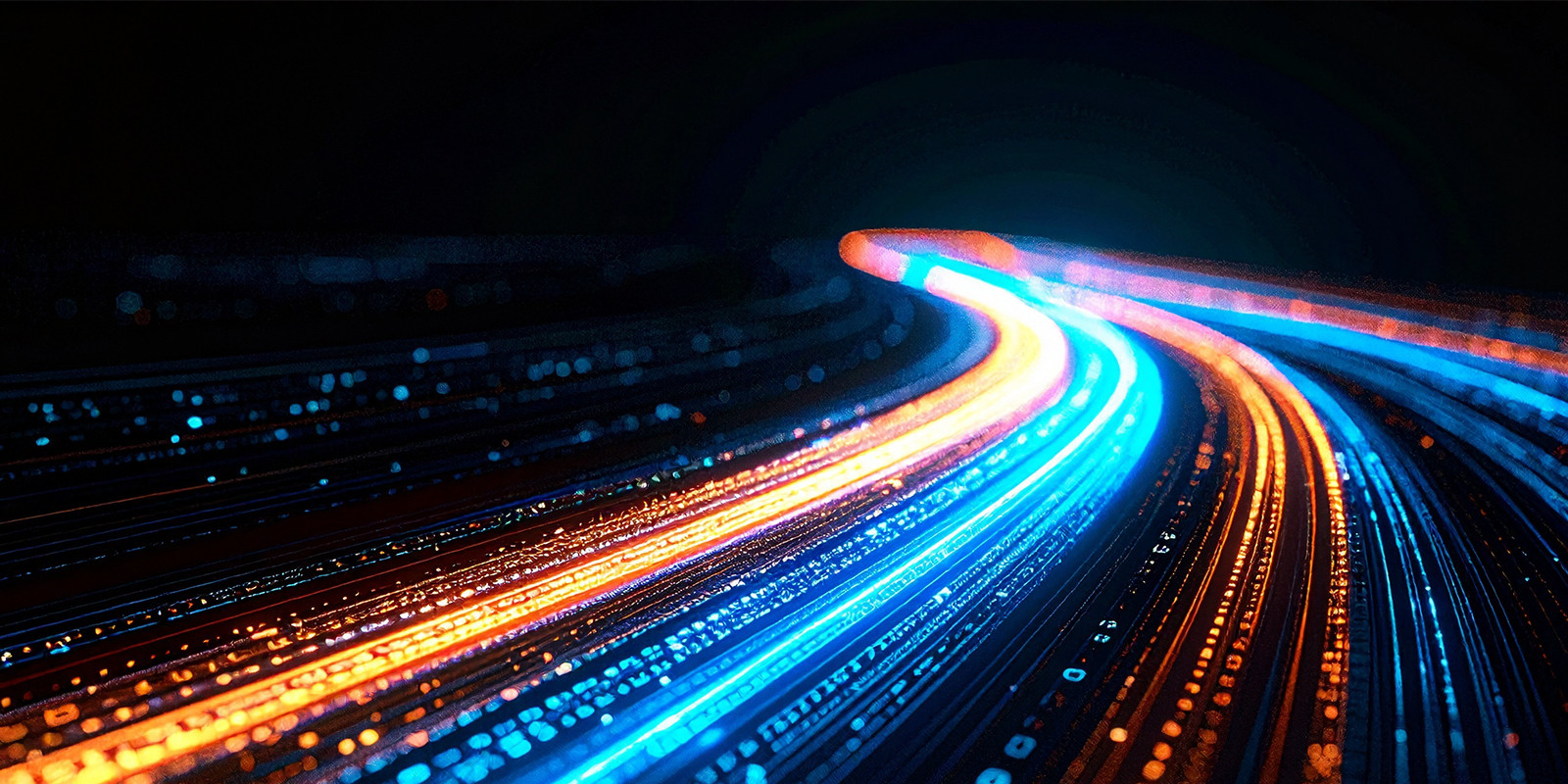  series of glowing lights stretching along a dark road, enhancing the nighttime scenery with their warm illumination.
