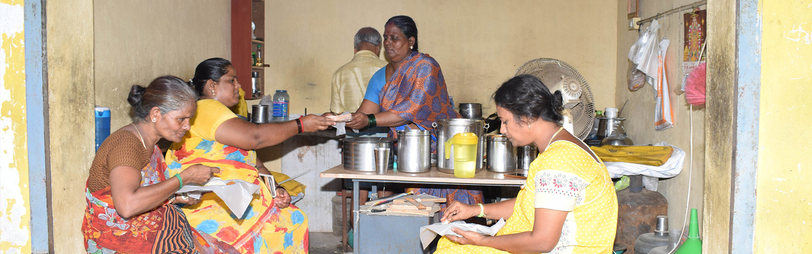 A lady is serving food to others