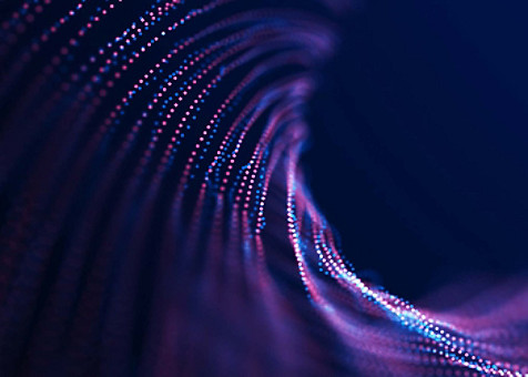 Abstract image of purple and blue dots making circular patterns against a dark background