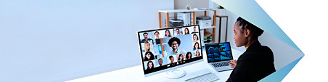 a woman looking at a laptop screen where her teamamtes are on video call