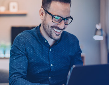 a happy man working on the laptop