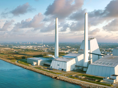 A birdseye view of a factory building with two chimneys