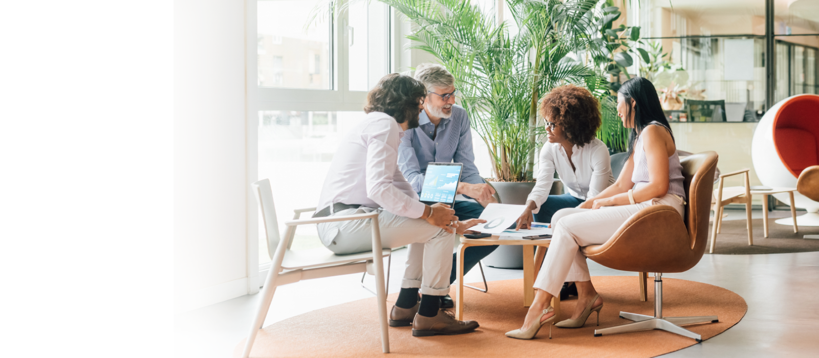 Two women and two men sitting around a coffee table in discussion