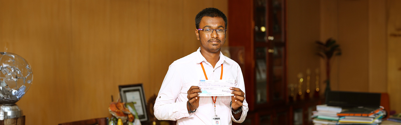 A student with his scholarship cheque