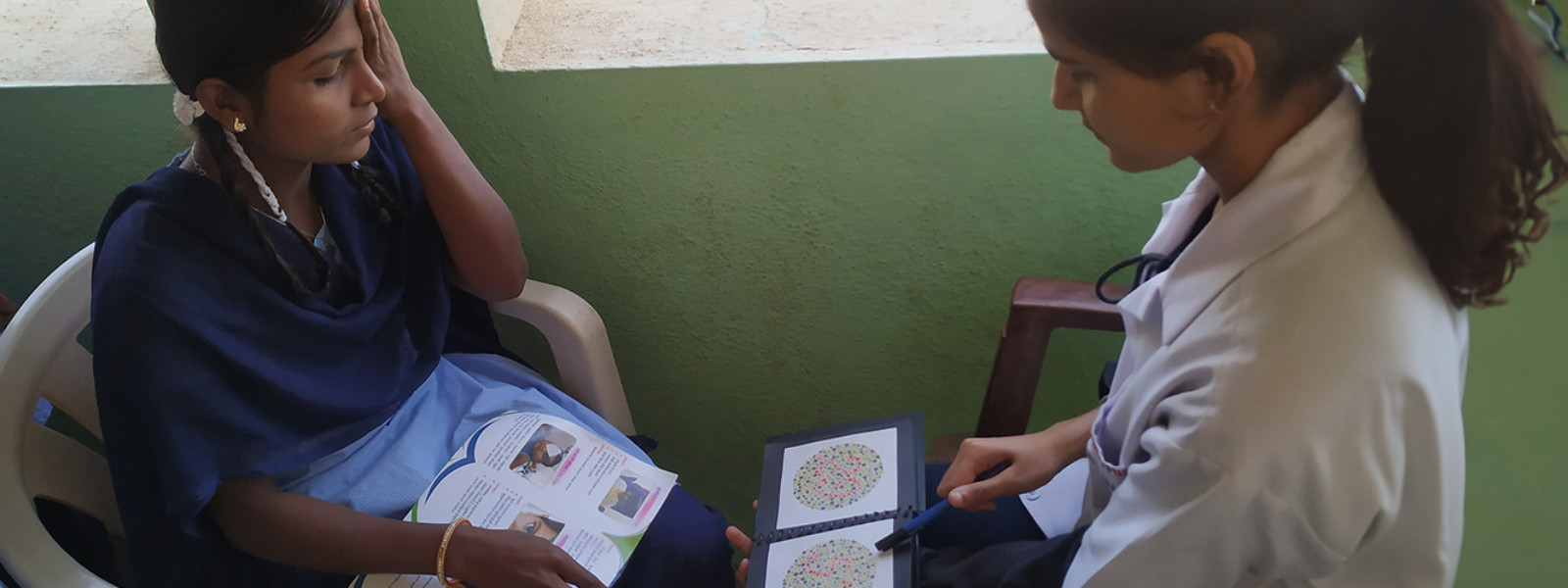 A girl is closing her eyes and reading something