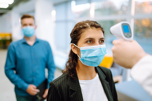 a person getting temperature checked