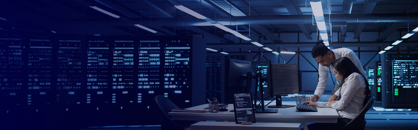 Teamworking colleagues in high tech data center managing and maintaining databases, ensuring data integrity, security and availability