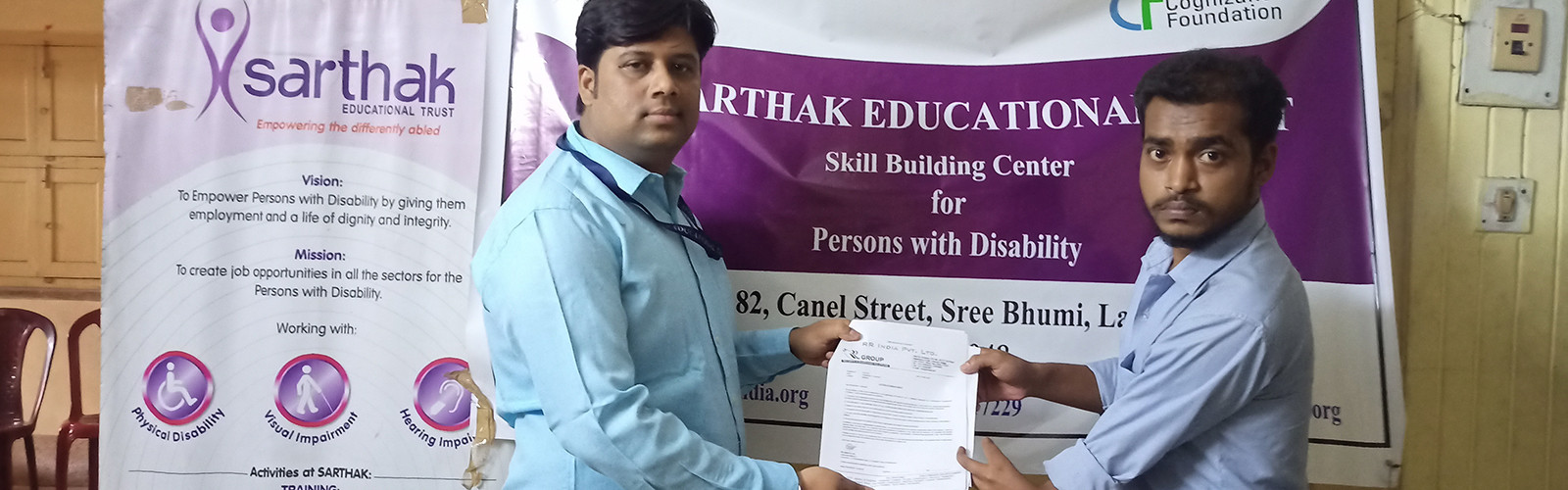 Teacher is distributing a certificate to a student