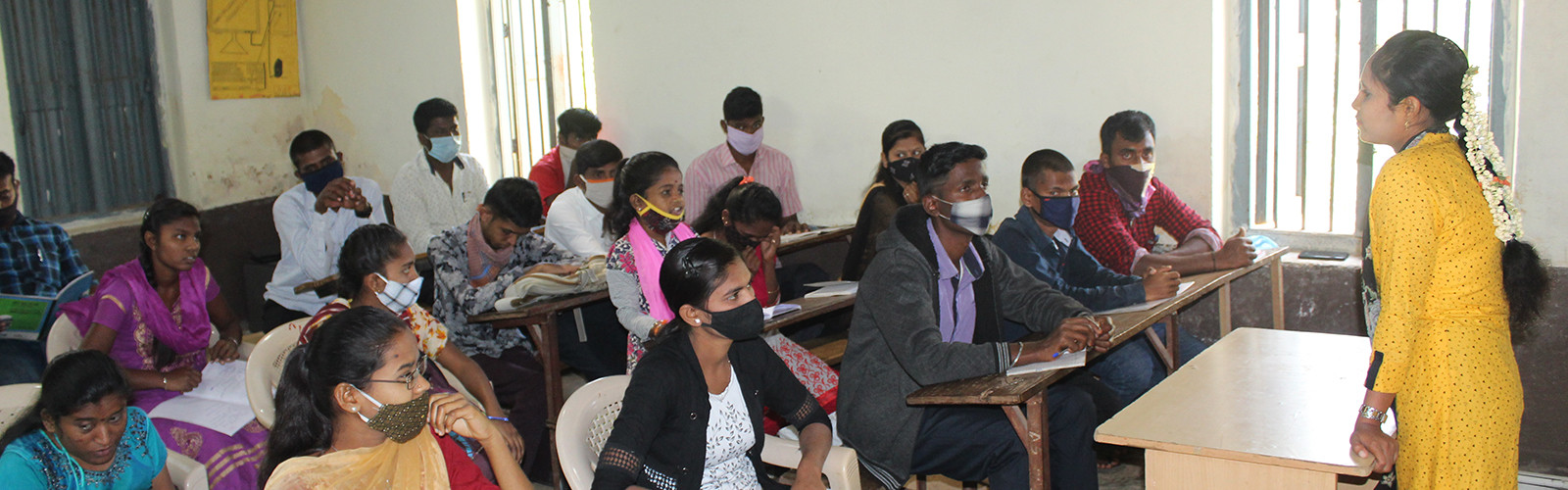 Students are sitting in the class and listening to teacher