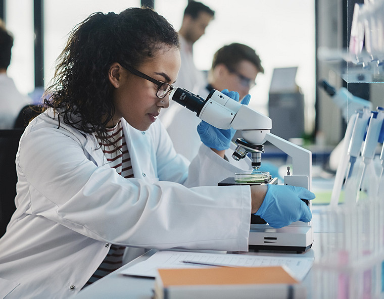 Technicians using a microscope.