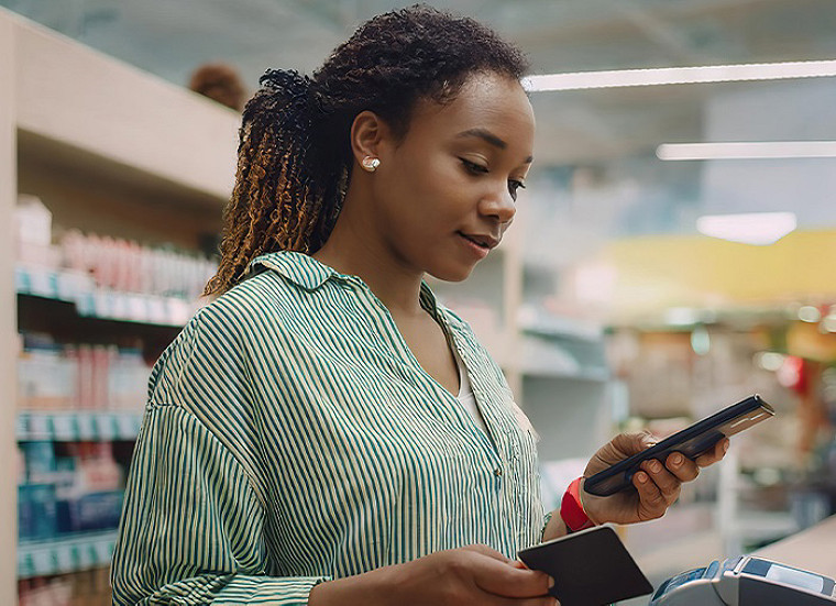 Close up view of a paying at a merchant by using mobile phone.