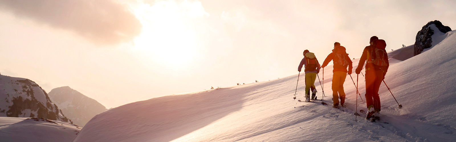 Three people skiing in a row