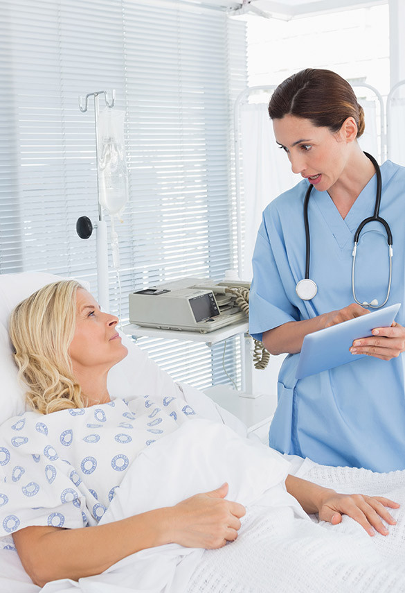 Doctor using tablet while visiting patient