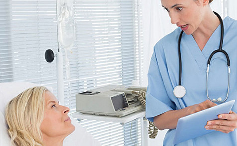 Female nurse checking a female blonde patient