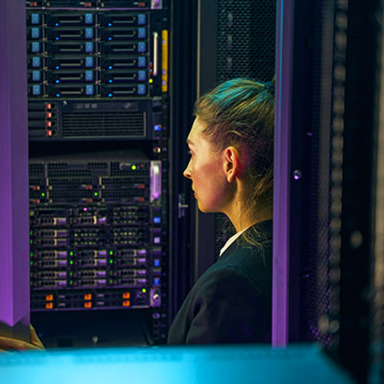 women inspecting data center server room
