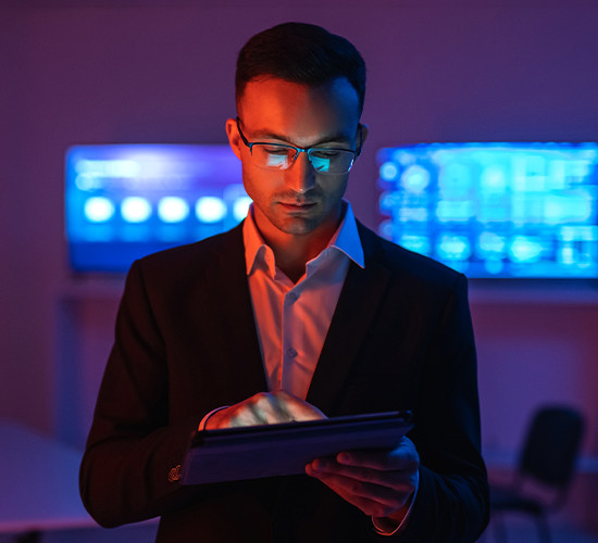 Professional analyzing tablet data in cybersecurity operations center background