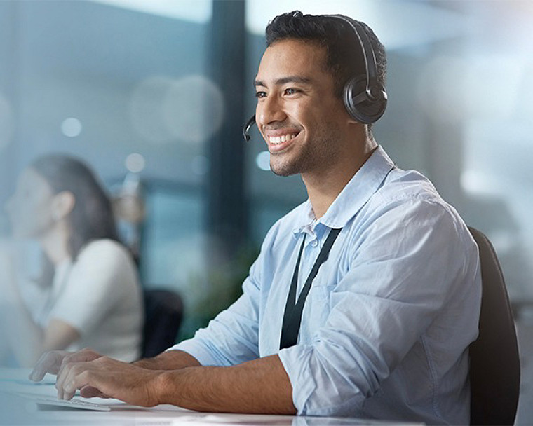An office worker speaking through headphones