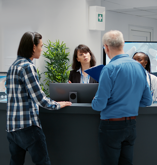A diverse group of people standing at a medical reception desk