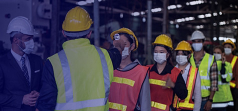 Masked employees getting temperature measured