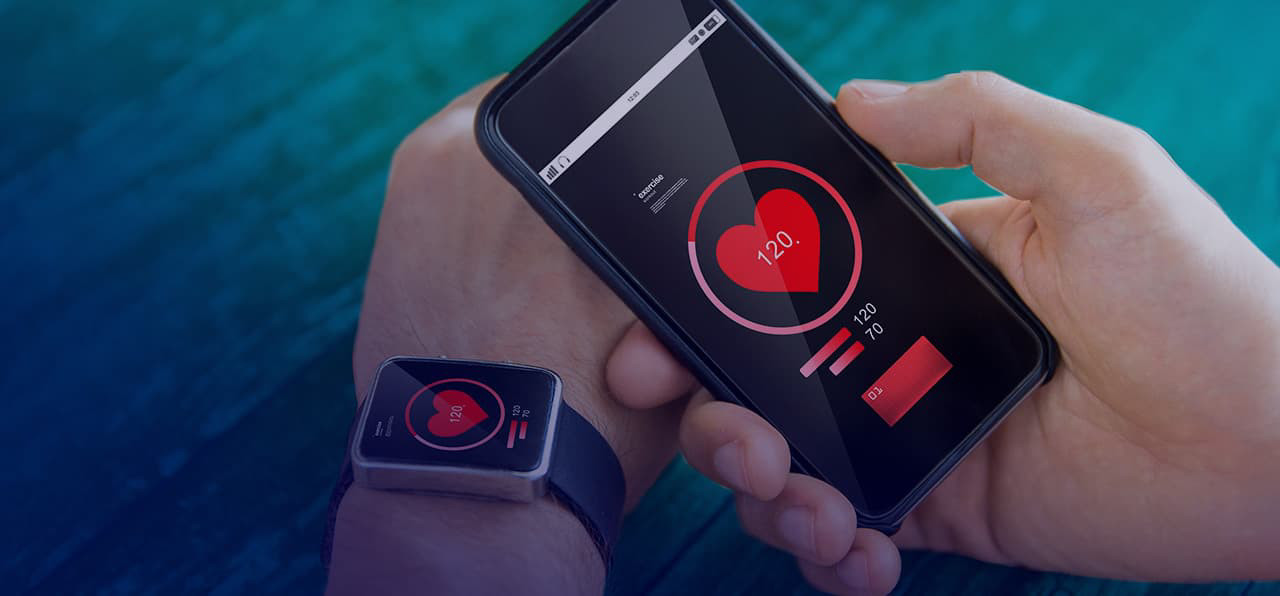 Photo of a hand holding a smartphone and smartwatch showing health data