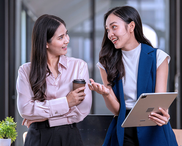Two women engaged in a discussion at the office.